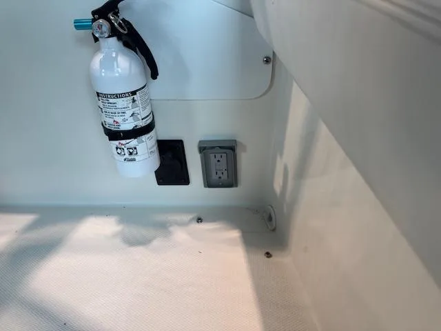 Slide: The Image of Fire extinguisher and electrical outlets in 2003 Carver 360 Sport Sedan interior. - 19