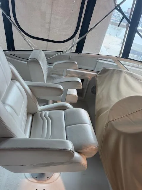 Slide: The Image of 2003 Carver 360 Sport Sedan interior with white leather seating and covered dashboard. - 20