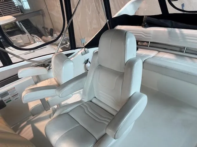 Slide: The Image of 2003 Carver 360 Sport Sedan interior with white leather seating and helm. - 21