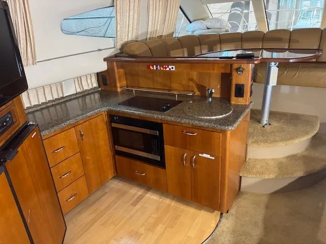 Slide: The Image of 2003 Carver 360 Sport Sedan interior with kitchen and seating area. - 25