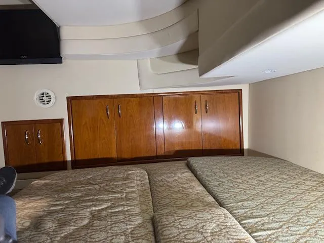 Slide: The Image of Interior cabin of 2003 Carver 360 Sport Sedan with wood cabinets and patterned bedding. - 32