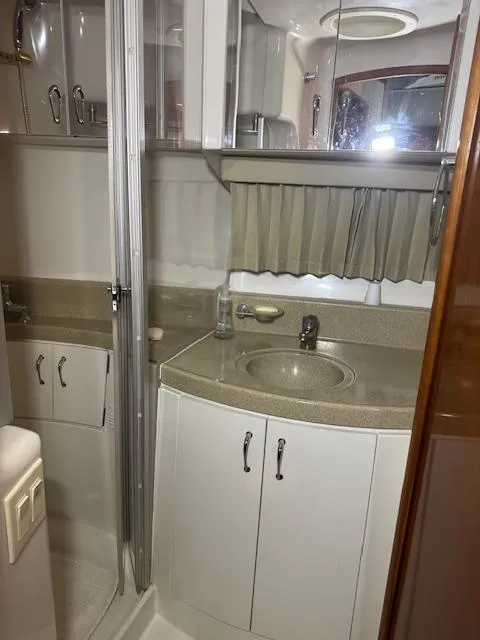Slide: The Image of 2003 Carver 360 Sport Sedan bathroom with sink, mirror, and storage cabinets. - 33
