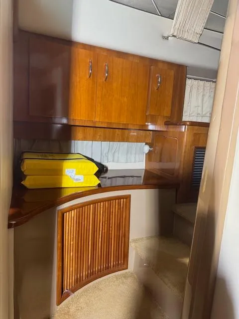 Slide: The Image of 2003 Carver 360 Sport Sedan interior with wooden cabinets and yellow life jackets. - 41