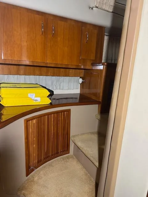 Slide: The Image of Interior of 2003 Carver 360 Sport Sedan with wooden cabinets and carpeted steps. - 42