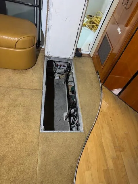 Slide: The Image of Open hatch in 2003 Carver 360 Sport Sedan interior, revealing mechanical components. - 45