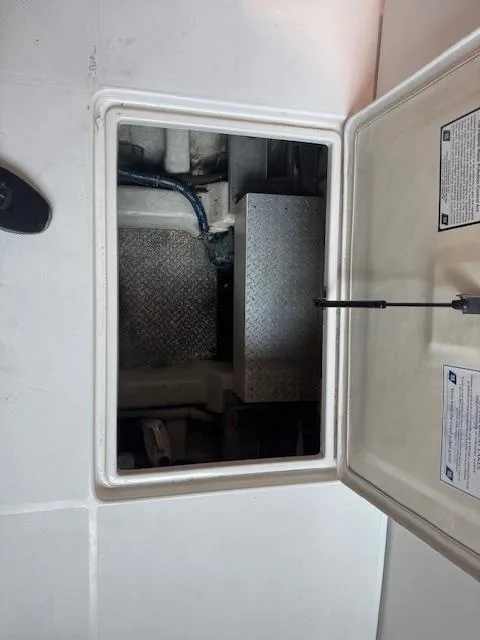 Slide: The Image of Engine compartment of a 2003 Carver 360 Sport Sedan, showing interior components and access hatch. - 9