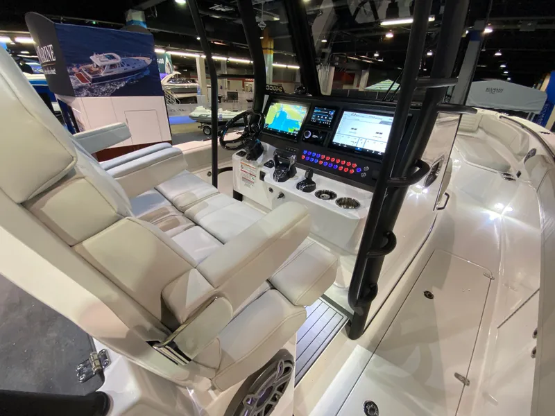 Slide: The Image of 2025 Edgewater 340CC boat interior with advanced navigation system and luxurious seating. - 14
