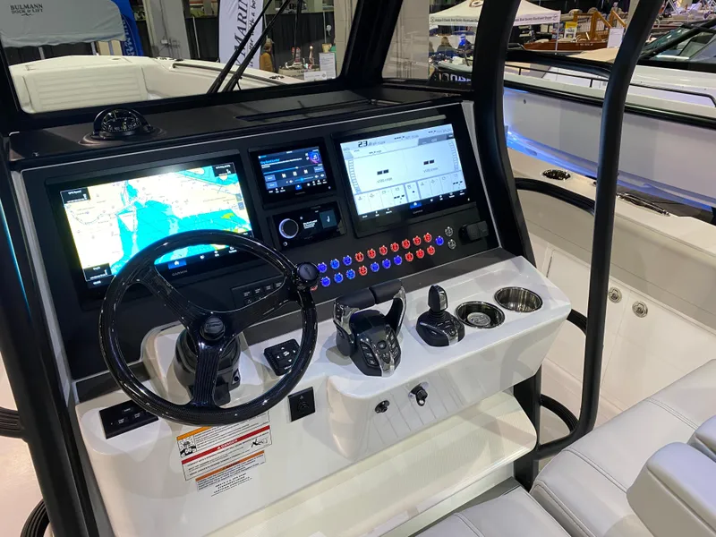 Slide: The Image of 2025 Edgewater 340CC boat dashboard with advanced navigation and control systems. - 18
