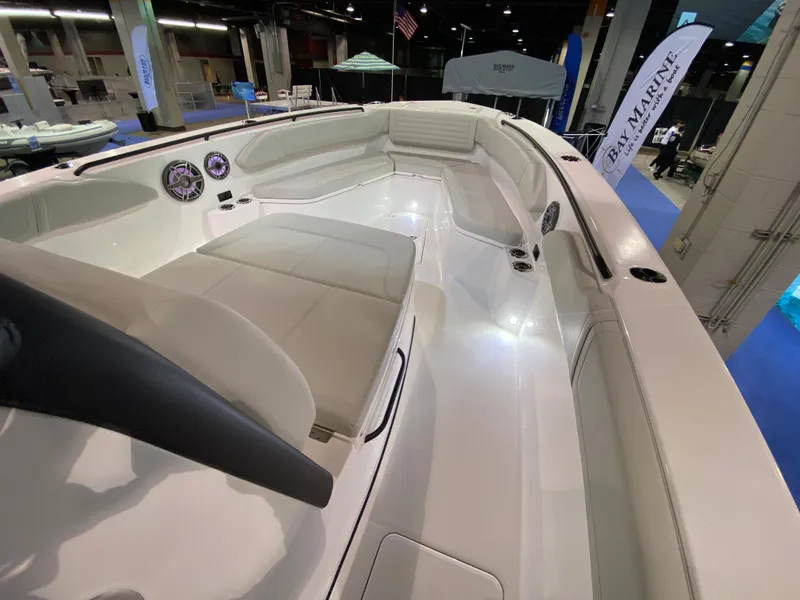 Slide: The Image of 2025 Edgewater 340CC boat interior with sleek seating and modern design at a boat show. - 20