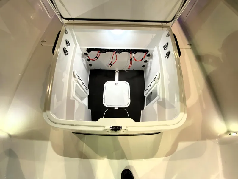 Slide: The Image of 2025 Edgewater 340CC boat storage compartment with open hatch and organized wiring. - 24