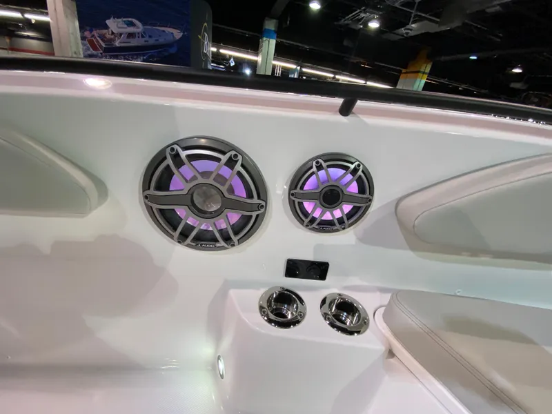 Slide: The Image of 2025 Edgewater 340CC boat interior with illuminated speakers and cup holders. - 28