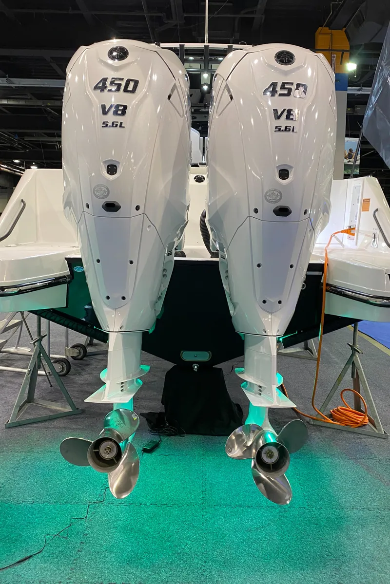 Slide: The Image of Twin 450 V8 engines on a 2025 Edgewater 340CC boat, displayed indoors. - 3