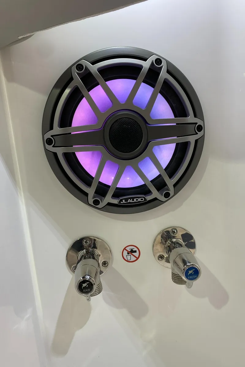 Slide: The Image of Speaker and controls on 2025 Edgewater 340CC boat, featuring illuminated audio system. - 33