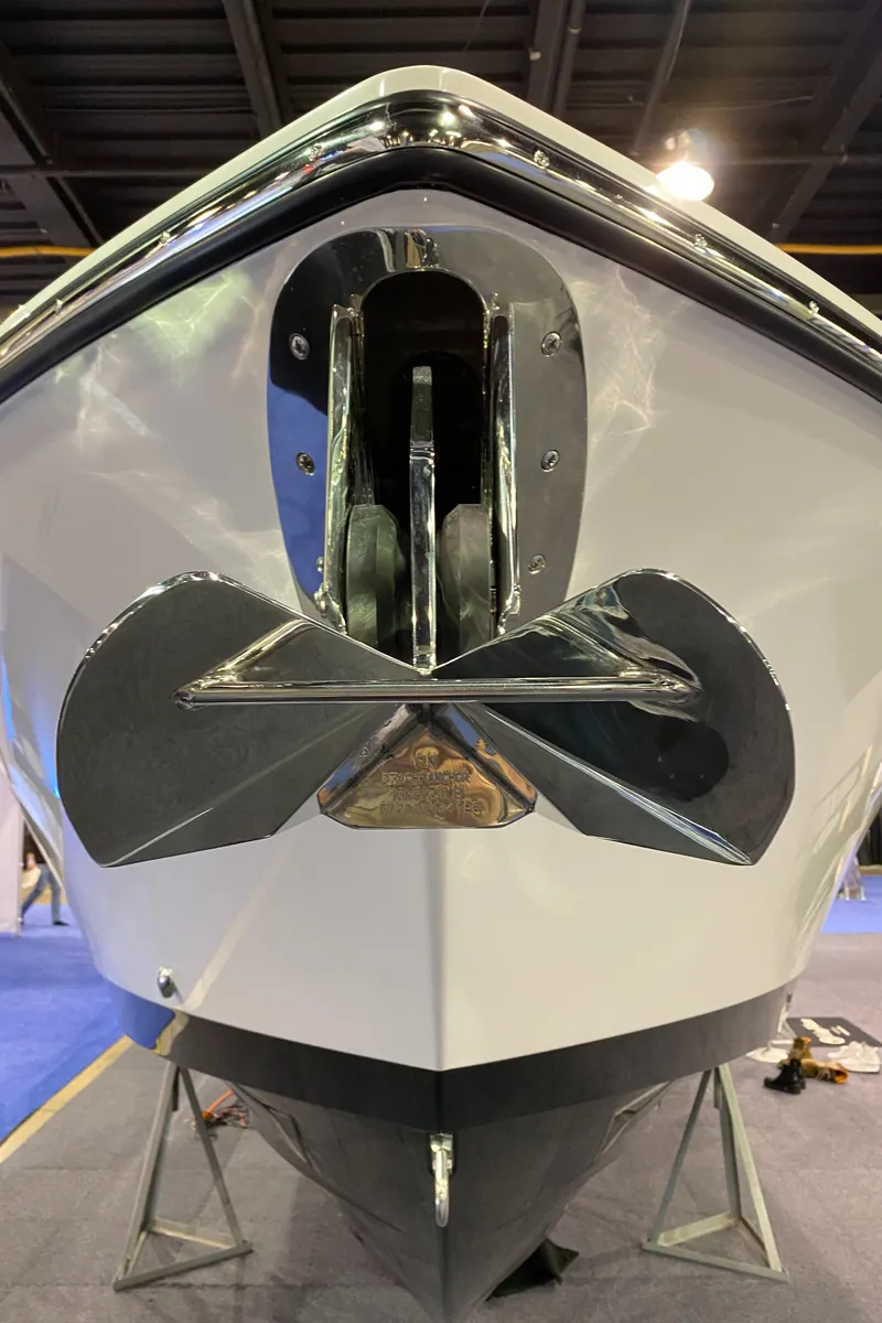Slide: The Image of 2025 Edgewater 340CC boat bow with anchor, displayed indoors. - 42