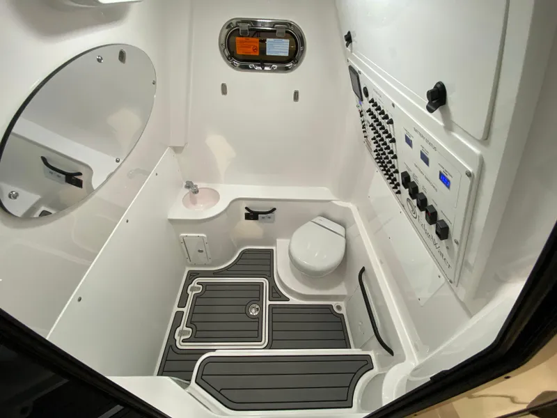 Slide: The Image of Interior of 2025 Edgewater 340CC boat featuring a compact bathroom with modern amenities. - 7