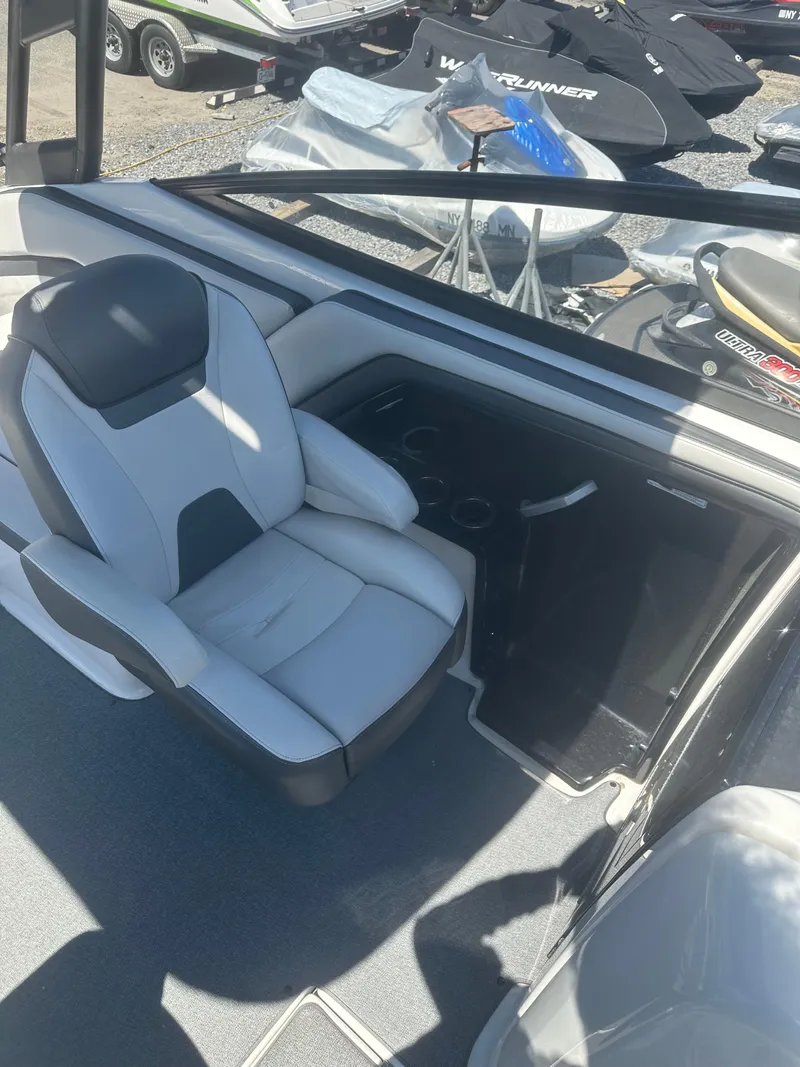 Slide: The Image of 2019 Yamaha AR240 boat interior with a comfortable white and gray seat. - 10