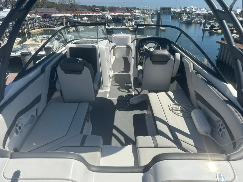 Slide: The Image of 2019 Yamaha Boats AR240 interior with seating, docked at marina. - 11