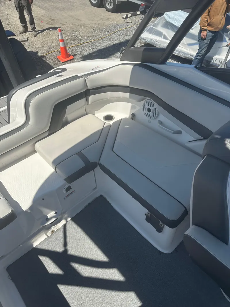 Slide: The Image of 2019 Yamaha Boats AR240 interior with cushioned seating and speaker. - 13