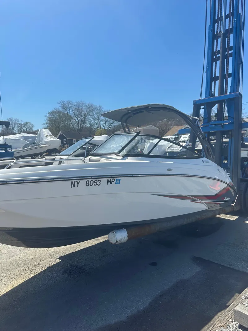 Slide: The Image of 2019 Yamaha AR240 boat on lift, sunny day, marina background. - 5