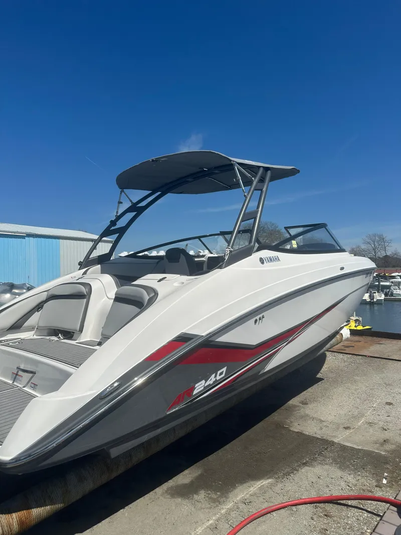 Slide: The Image of 2019 Yamaha AR240 boat with sleek design, docked under clear blue sky. - 8