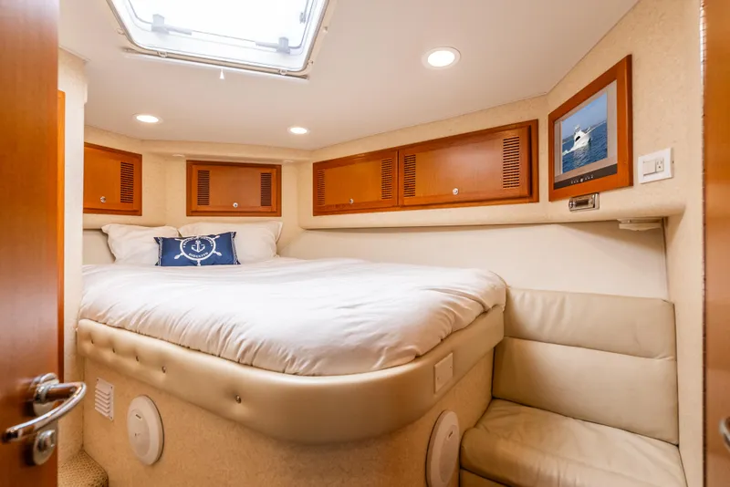 Slide: The Image of Luxurious cabin interior of 2004 Cabo 48 Flybridge yacht with cozy bed and seating. - 10