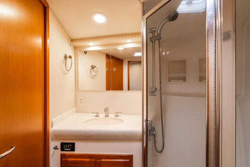 Slide: The Image of Bathroom interior of 2004 Cabo 48 Flybridge yacht with shower and vanity. - 16