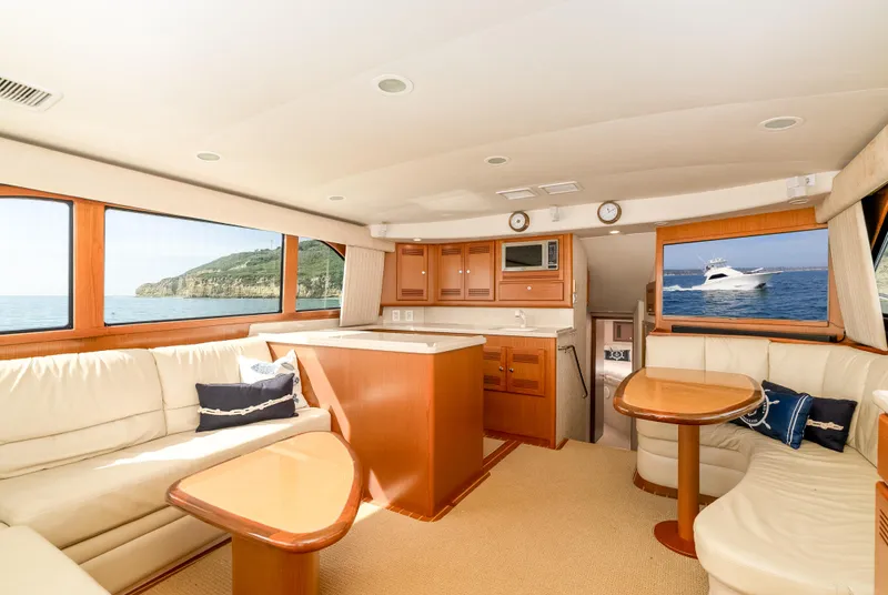 Slide: The Image of Luxurious interior of 2004 Cabo 48 Flybridge yacht with elegant seating and ocean views. - 2