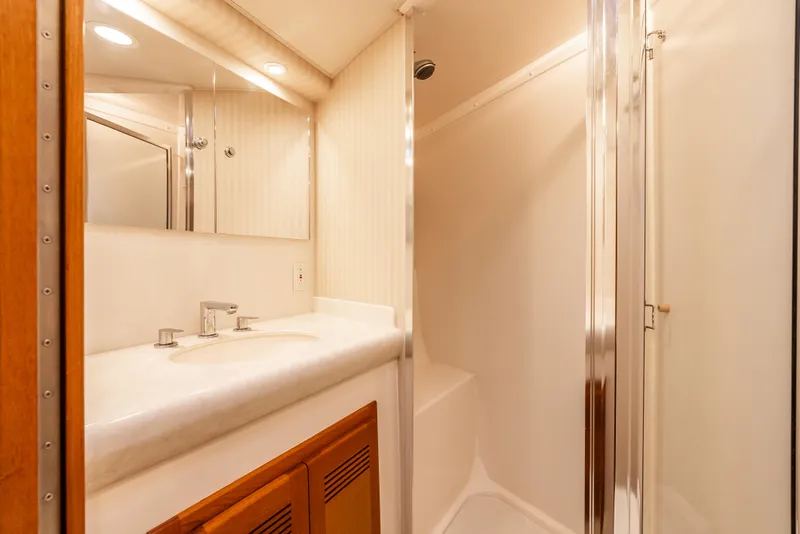 Slide: The Image of Luxurious bathroom in 2004 Cabo 48 Flybridge yacht with modern fixtures and shower. - 20