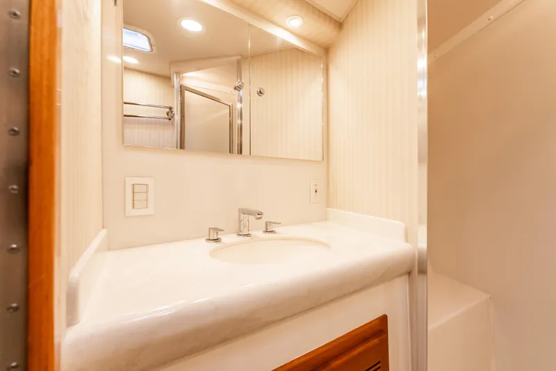 Slide: The Image of 2004 Cabo 48 Flybridge bathroom with modern sink and mirror. - 21