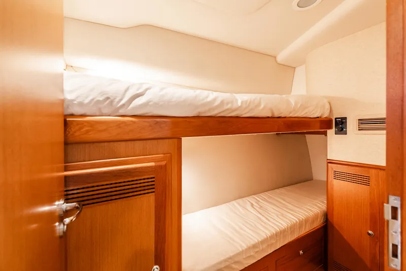 Slide: The Image of Bunk beds in 2004 Cabo 48 Flybridge yacht cabin with wooden finish. - 22