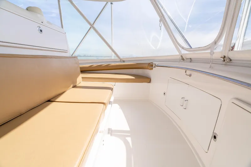 Slide: The Image of 2004 Cabo 48 Flybridge interior with tan seating and white cabinetry. - 27