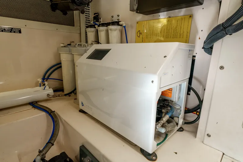 Slide: The Image of Engine room of 2004 Cabo 48 Flybridge with mechanical equipment and wiring. - 31