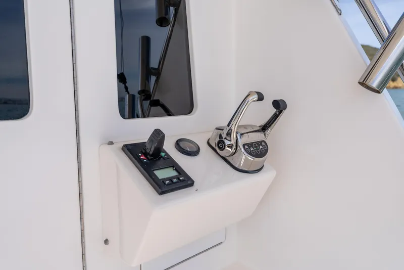 Slide: The Image of Control panel of 2004 Cabo 48 Flybridge yacht with throttle and navigation instruments. - 37