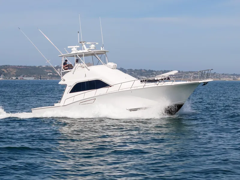 Slide: The Image of 2004 Cabo 48 Flybridge yacht cruising on open water. - 39