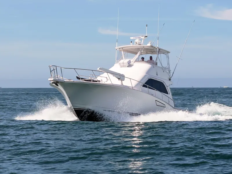 Slide: The Image of 2004 Cabo 48 Flybridge yacht cruising on open water. - 41