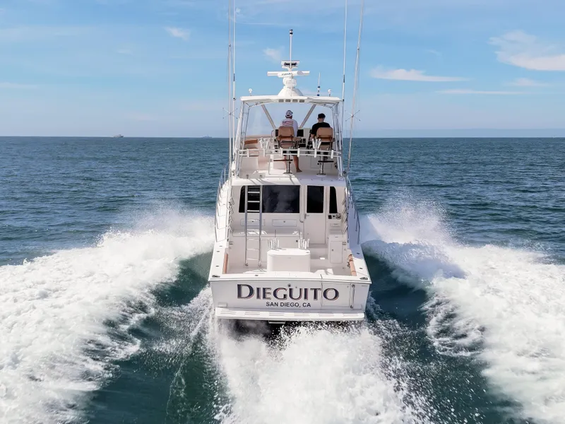 Slide: The Image of 2004 Cabo 48 Flybridge yacht cruising on open sea, rear view. - 42