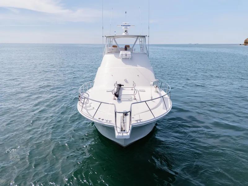 Slide: The Image of 2004 Cabo 48 Flybridge yacht on open water, front view. - 43