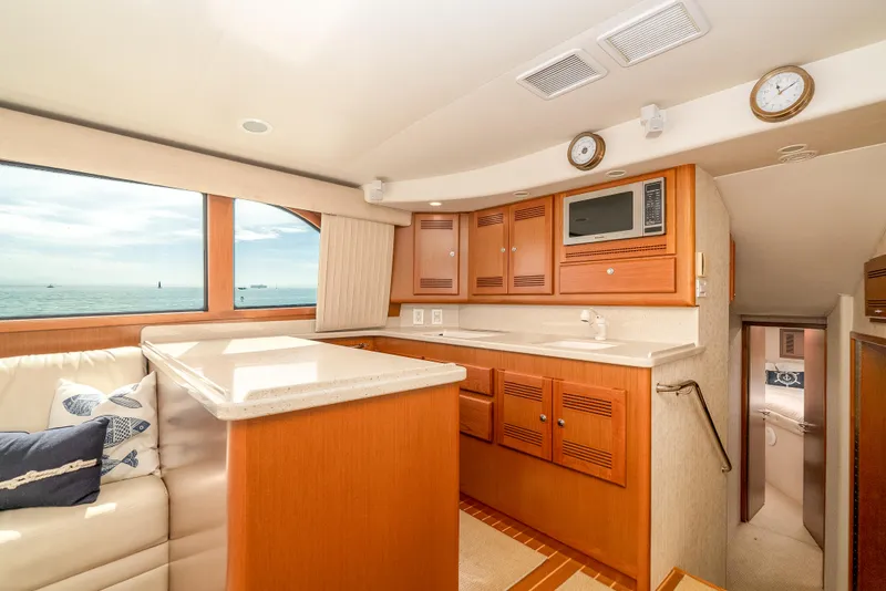 Slide: The Image of Luxurious 2004 Cabo 48 Flybridge yacht interior with modern kitchen and ocean view. - 6