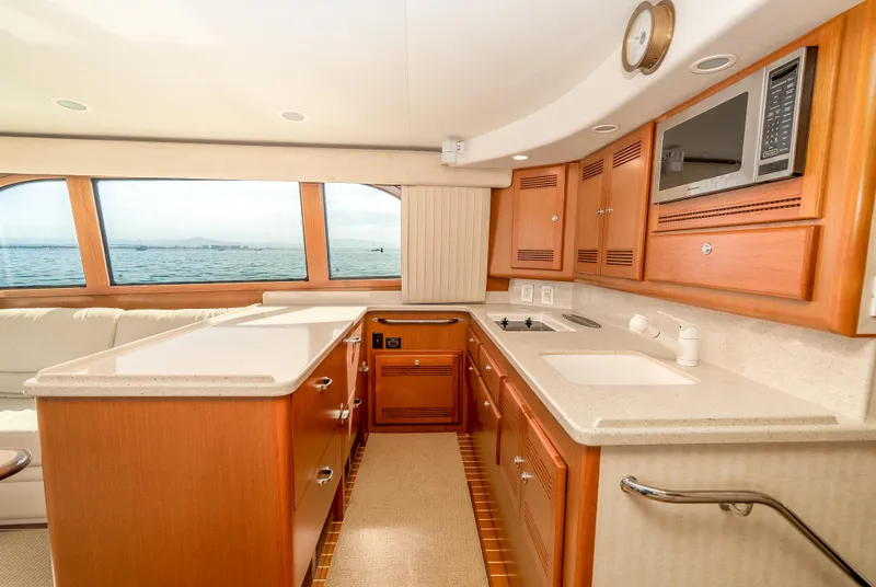 Slide: The Image of Luxurious 2004 Cabo 48 Flybridge yacht interior with modern kitchen and ocean view. - 7