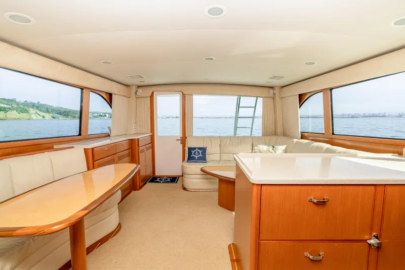 Slide: The Image of Luxurious interior of 2004 Cabo 48 Flybridge yacht with elegant wood finishes. - 8