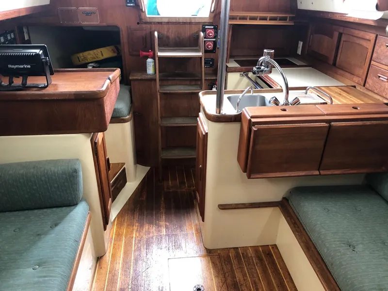 Slide: The Image of Interior of 1992 Pacific Seacraft 34 Crealock sailboat with wood finish and seating. - 13