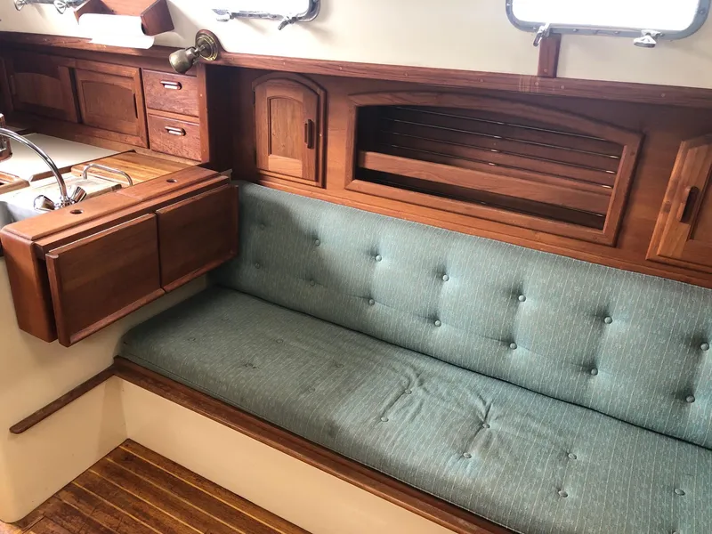 Slide: The Image of Interior of 1992 Pacific Seacraft 34 Crealock with wooden cabinetry and cushioned seating. - 8