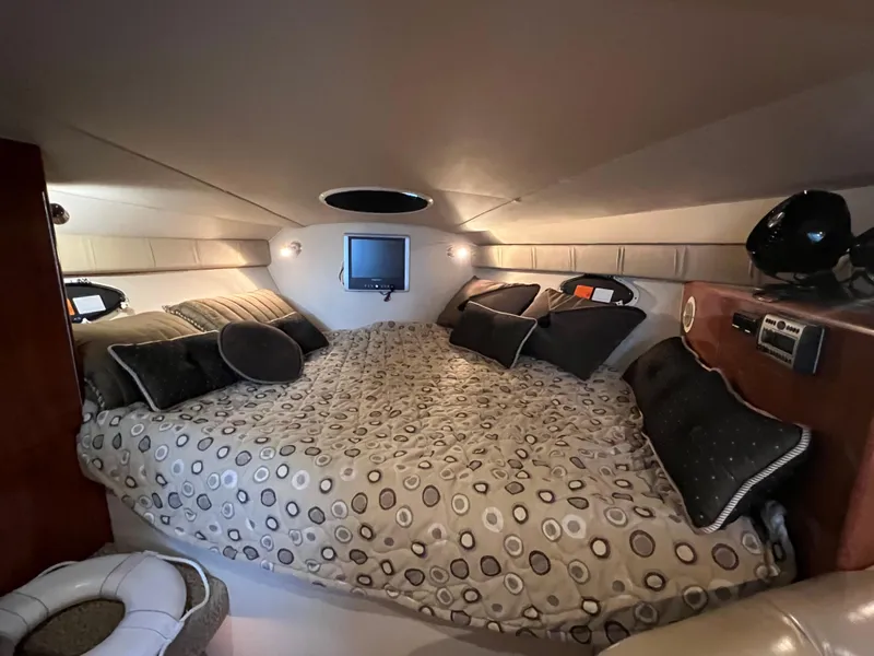 Slide: The Image of 2007 Larson Cabrio 330 cabin interior with cozy bed and modern amenities. - 11