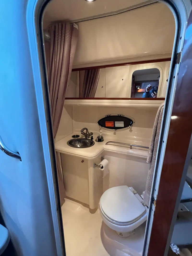 Slide: The Image of 2007 Larson Cabrio 330 bathroom with sink, toilet, and mirror. - 14