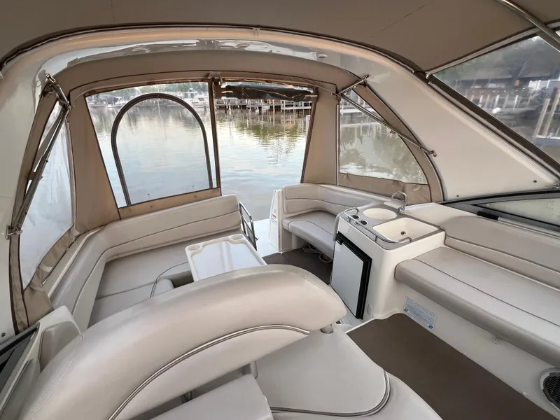 Slide: The Image of 2007 Larson Cabrio 330 boat interior with beige seating and water view. - 19
