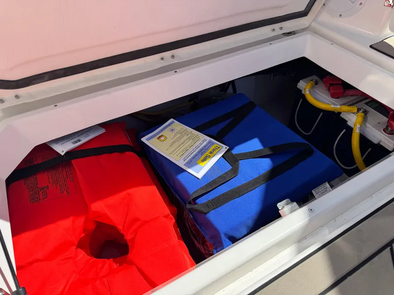 Slide: The Image of Storage compartment in 2025 Cutwater C-288 Coupe with life jackets and equipment. - 18