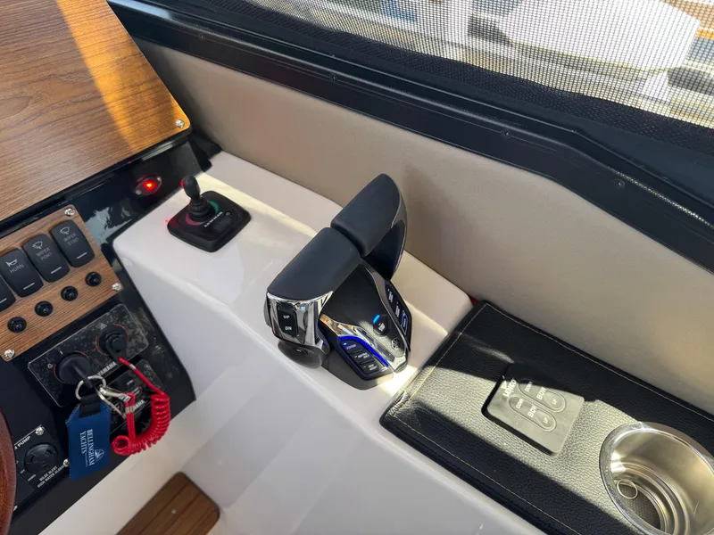 Slide: The Image of 2025 Cutwater C-288 Coupe cockpit controls with modern throttle and switch panel. - 24