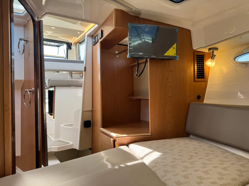 Slide: The Image of 2025 Cutwater C-288 Coupe interior with cozy cabin, TV, and modern amenities. - 28