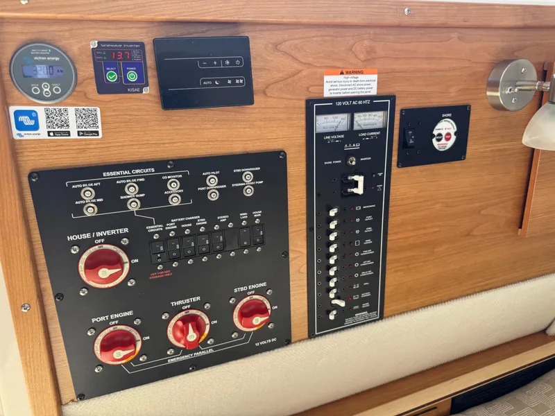 Slide: The Image of Electrical control panel of 2025 Cutwater C-288 Coupe boat with various switches and gauges. - 35