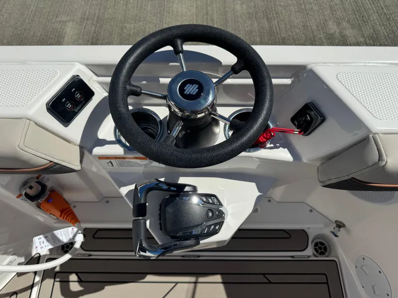 Slide: The Image of 2025 Cutwater C-288 Coupe helm with steering wheel and controls. - 5
